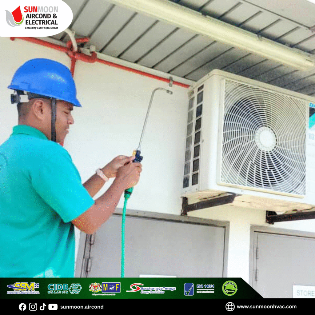 a man wearing a hard hat and holding a hose