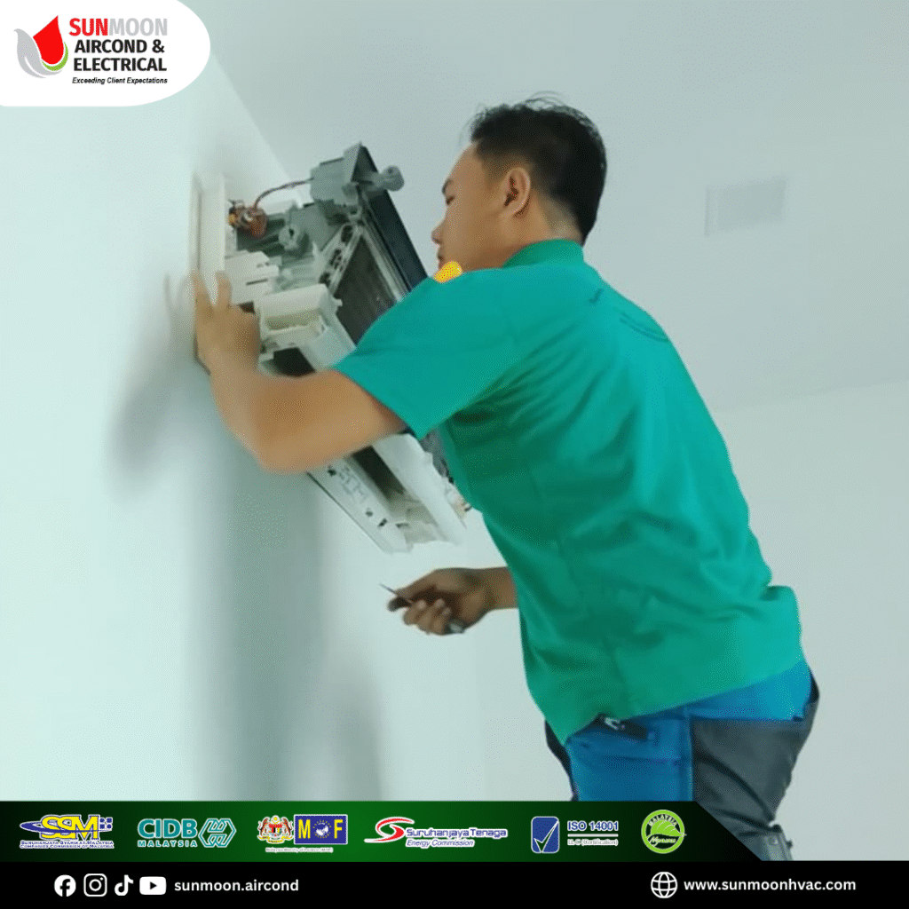 technician checking & repairing aircond blowing hot air in Klang Valley